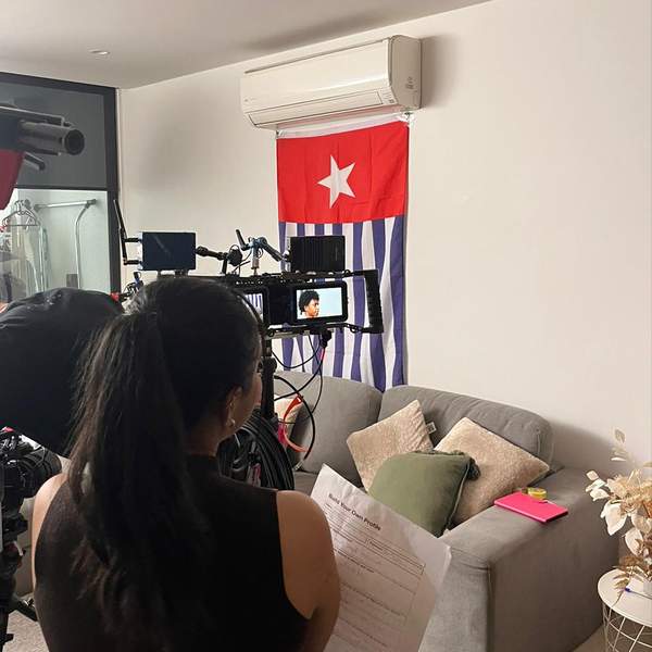 Image of Cyndi in front of a Morning Star Flag.