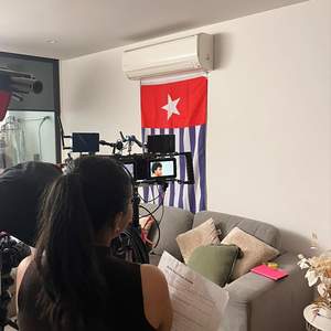 Image of Cyndi in front of a Morning Star Flag.