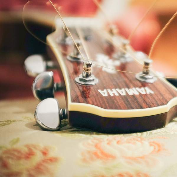 Guitar on Bed Stock Image